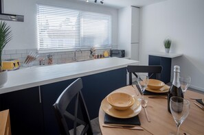 Enjoy meals in this well-equipped kitchen with a central island, oven, and sink, perfect for cooking and dining with a view.