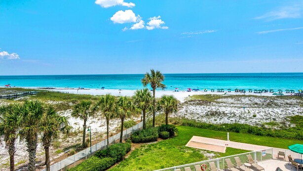 A beach view with palm trees, a fenced area, and a patio with chairs. - ✨FAB Gulf Views~Pool~Beach Svc~2BR Destin on the Gulf 402 (Destin)