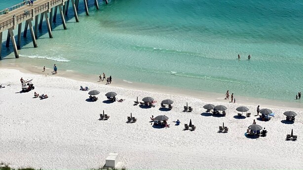 A pier extending into the ocean with a beach in the foreground. - 4-bedroom oasis  in Navarre with enclosed heated  pool (Navarre)