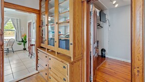 A room with wooden cabinetry, a television, and a potted plant. - Home on the River - stunning views and Comfy Beds (Waterford)