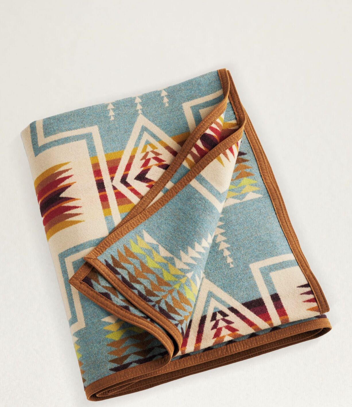 A folded blanket with a geometric pattern.