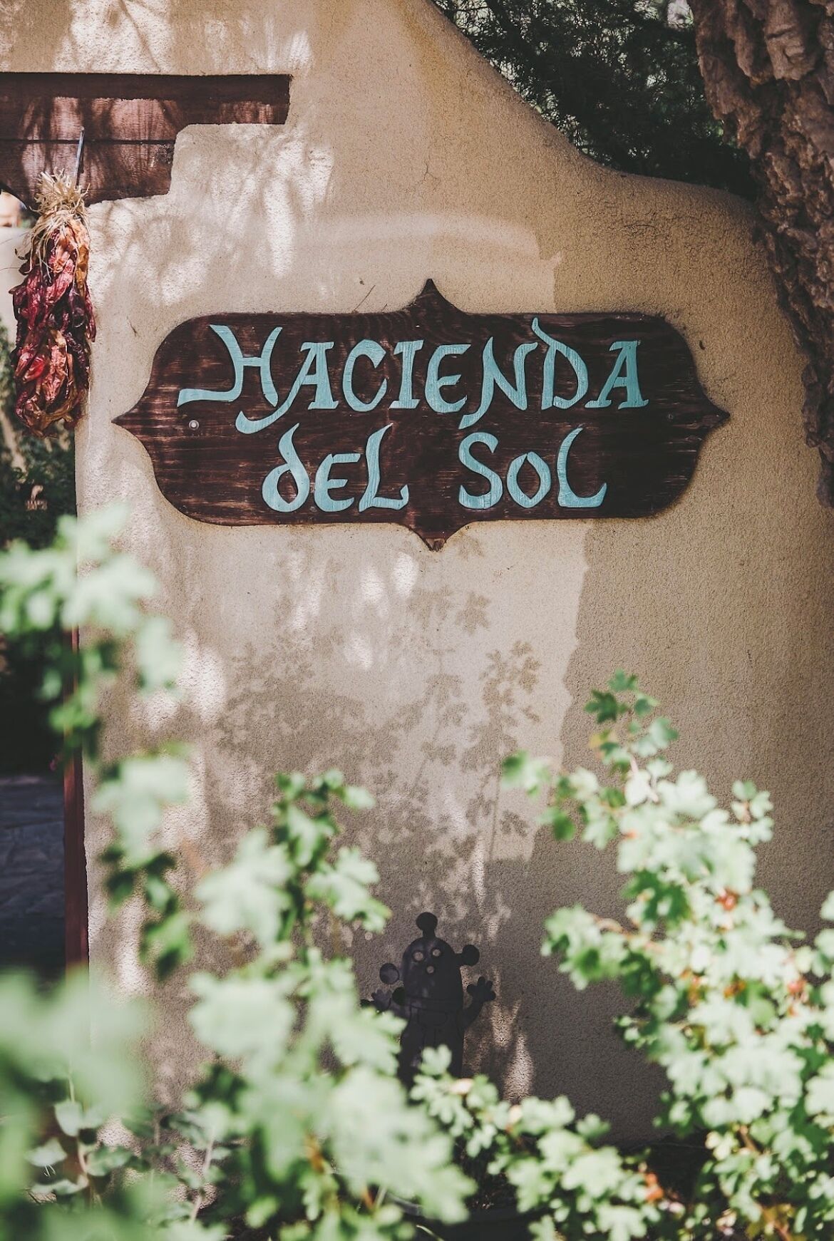 A sign reading "Hacienda del Sol" on a wall.