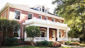 Stroll up to the charming entrance, flanked by evenly spaced windows and a central doorway.
