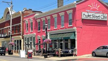 A street view with a red building labeled 'Front Street Cafe' and a visible storefront with outdoor seating.