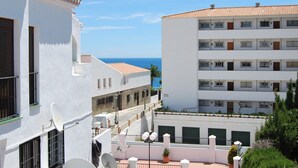 A white building with balconies overlooking a coastal area. - Ap140 Alcazaba 2D (Nerja)