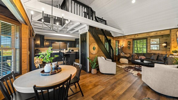 A spacious loft with a dining area, kitchen, and living room. - Creekside Cabin Smoky Mtn Views Arcade HotTub Pet (Sevierville)
