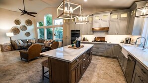 A spacious kitchen with a large island, granite countertops, and light gray cabinetry. - 4br, 3ba, pool near TPC in Scottsdale (Scottsdale)