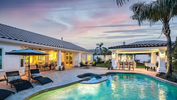 A residential property with a swimming pool, outdoor seating, and a covered patio area. - 4br, 3ba, pool near TPC in Scottsdale (Scottsdale)