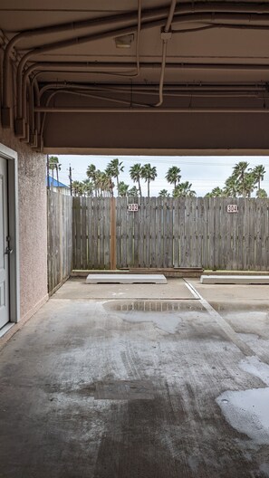 Enter the secure parking area with a gated entrance and designated parking spaces.