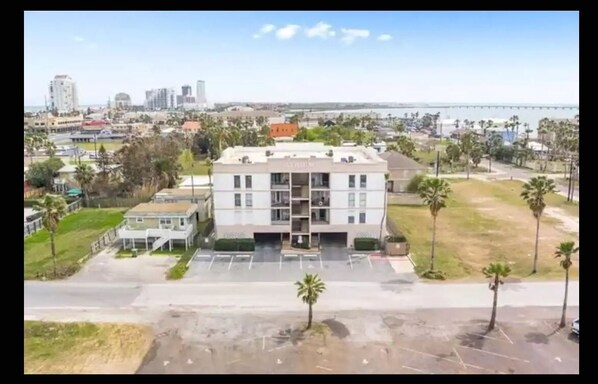 Situated in an urban area, this building offers a view of the sea and a bridge in the background.