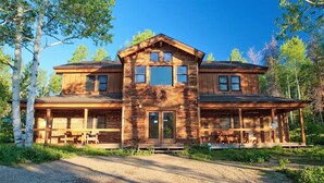 A two-story log cabin with a porch and outdoor seating. - Honeymoon Cabin - A Romantic 2 Person Cabin (Clark)