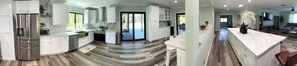 Enjoy meals in this well-equipped kitchen with a central island, oven, and large window offering a view of the outdoors.