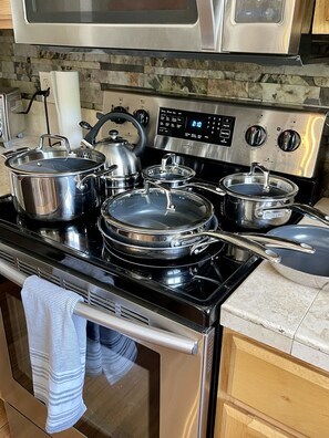 Enjoy cooking in this well-equipped kitchen with a stainless steel stove and oven, featuring a digital control panel.