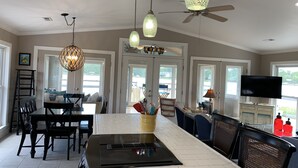 A spacious kitchen with a central island, pendant lights, and a ceiling fan. - Rivendock Rookery II: Waterfront Home w/Dock & Stunning Views (Oriental)