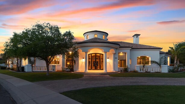 A large, two-story house with a circular front porch, a large window, and a well-maintained lawn. - Villa del Sol (Tempe)