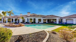 A large, modern house with a swimming pool, outdoor seating, and a well-maintained garden. - Villa del Sol (Tempe)