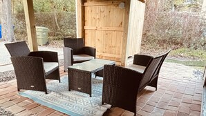 An outdoor patio with wicker furniture and a brick floor. - Unit C, Spirit of Folly, Pet Friendly,  2 short blocks - 100 yards to the beach (Folly Beach)
