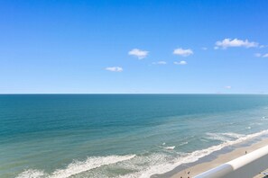 A beach with a clear sky and calm sea.