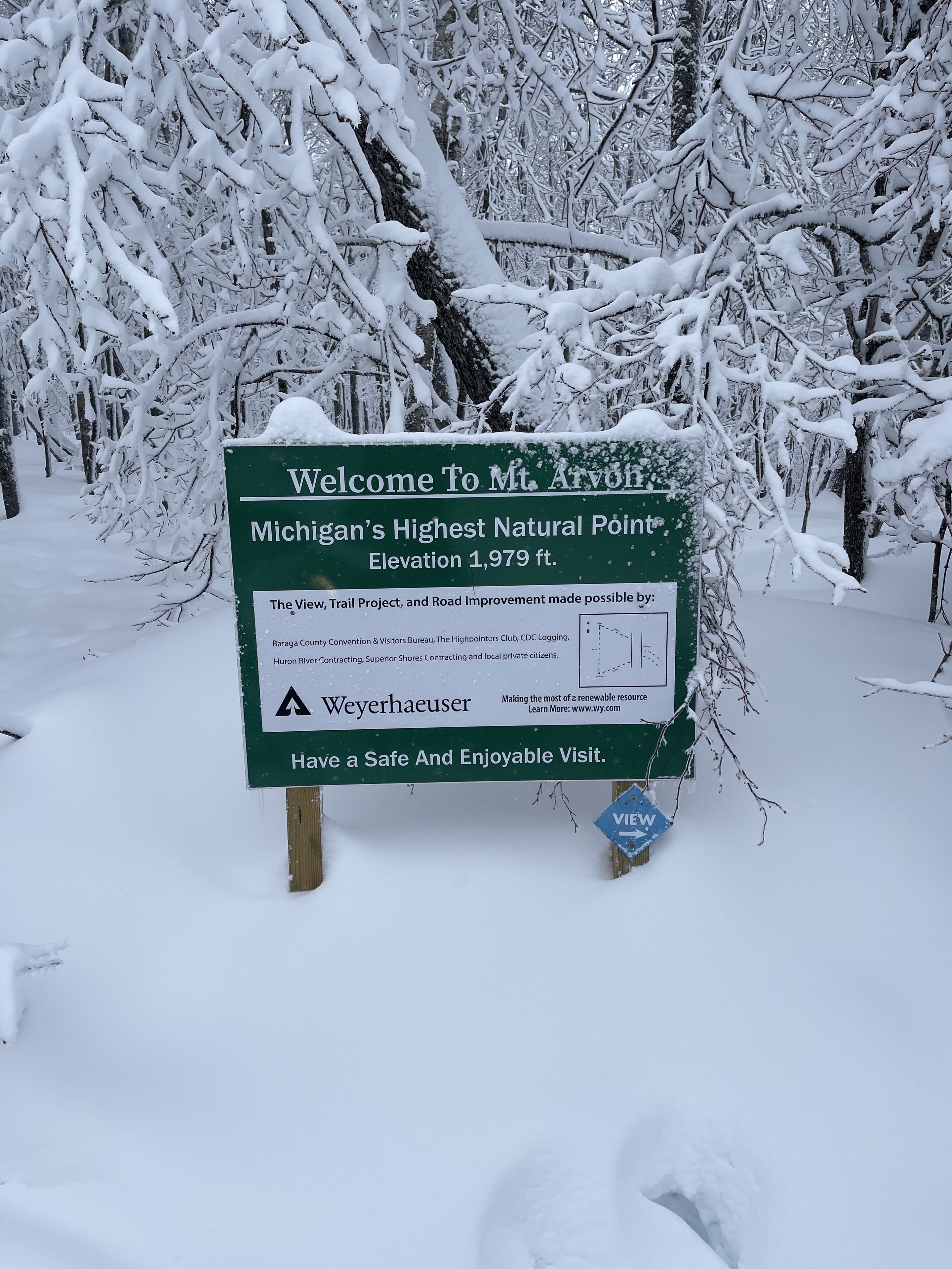 A sign welcoming visitors to Mt. Arvon, Michigan's highest natural point at 1,979 ft.