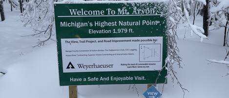 A sign welcoming visitors to Mt. Arvon, Michigan's highest natural point at 1,979 ft.