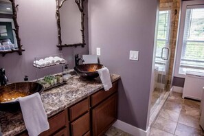 A bathroom with a granite countertop, a large vessel sink, and a glass shower enclosure. - Ride from this Mini Mansion to all the ATV Trails (Berlin)