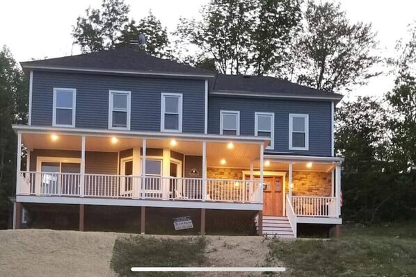 A two-story house with a covered porch and a small front entrance. - Ride from this Mini Mansion to all the ATV Trails (Berlin)