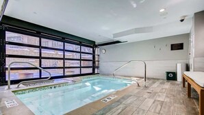 An indoor swimming pool with clear markings, a bench, and a view through large windows. - Luxury Ski-In/Out Residence at Golden Peak (Vail)