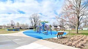 A playground with swings, slides, and a climbing structure.
