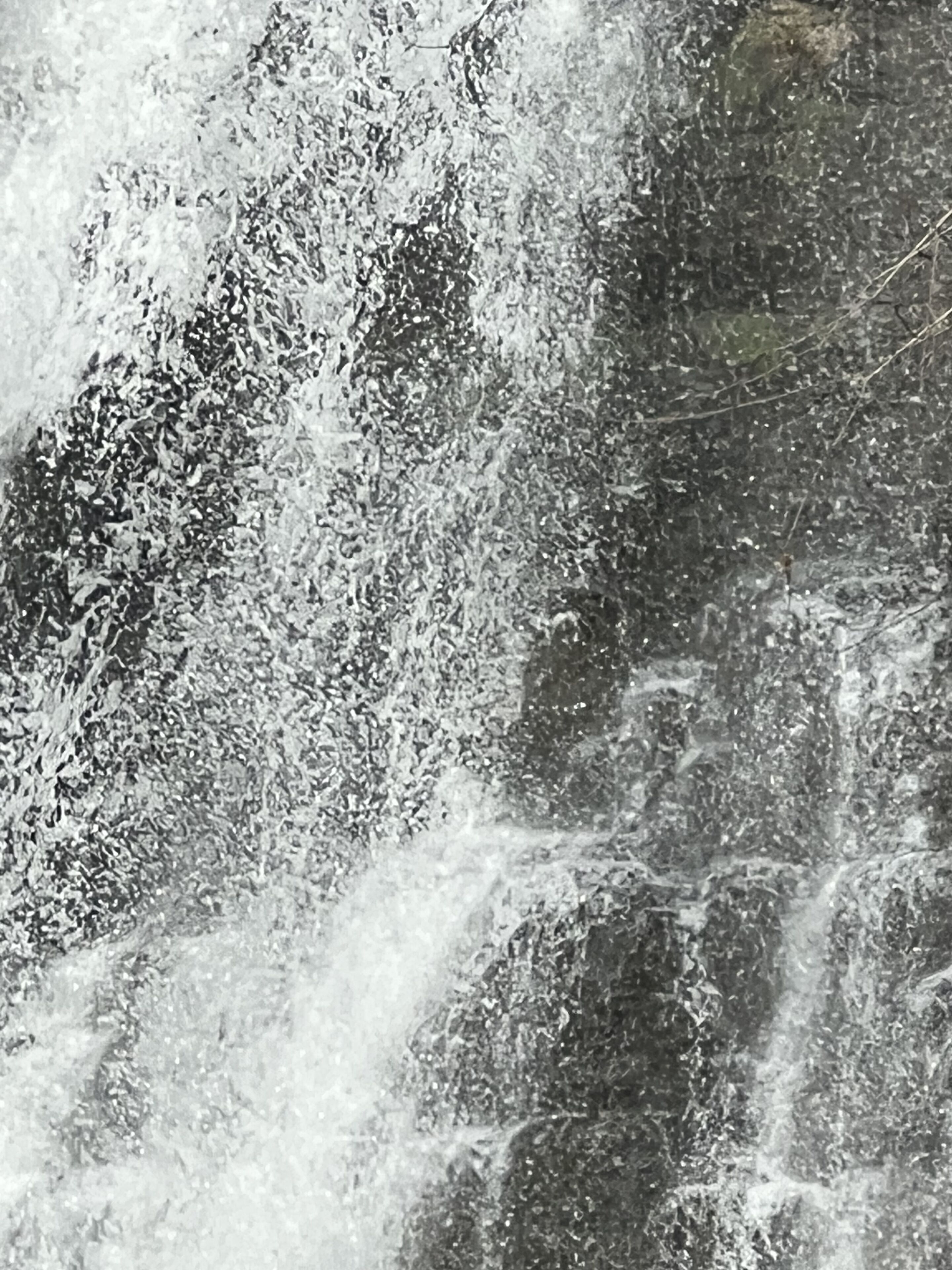 A close-up of a textured surface with a rough, uneven pattern.