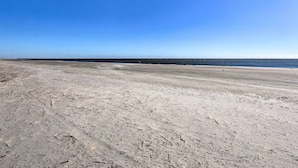 A wide, sandy beach with a clear blue sky. - Walk to Beach: Family Hilton Head Island Condo (Hilton Head Island)
