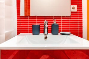 Bathroom features a sink, mirror, and power outlet.