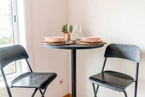 Enjoy meals in this cozy dining area with a round table and two chairs.
