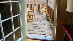 A wooden deck with chairs and a view of trees. - ADK Lake House Vacation, Cozy 5 Bedroom & 2 Bath (Old Forge)