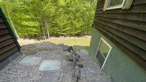 A stone pathway leading to a wooden house with a green exterior. - ADK Lake House Vacation, Cozy 5 Bedroom & 2 Bath (Old Forge)