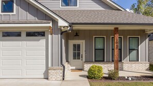 A residential house with a garage, a front door, and a small garden.