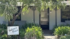 A property with a sign reading "22 Sabine's Place" and a contact number.