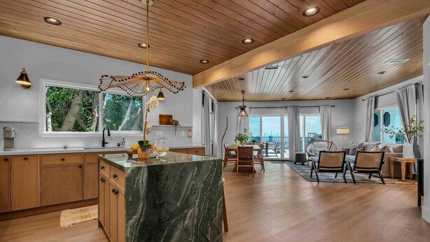 A spacious kitchen with wooden cabinets, a marble island, and pendant lighting. - Voted Guest Favorite! Get Wow'd! Stellar Views Hollywood Hills (Los Angeles)