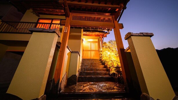 A traditional Japanese building with a wooden entrance gate, stone steps, and a lantern. - TAKETORI ROTEN (Beppu)