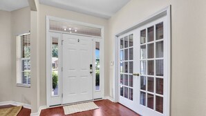 A hallway with a double door, a window with blinds, and a rug on the floor. - Spacious 4 bedroom house by OWA & Tanger Outlets, 15 mins from Beaches (Foley)