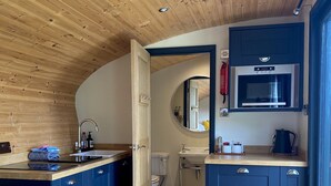 A compact kitchen with a wooden ceiling, a built-in oven, and a sink. - Robin’s Nest - ( Top Cabin )  - sleeps 2 guests (Foolow)