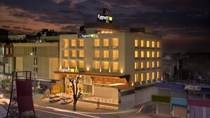 A hotel with a modern facade, multiple windows, and a prominent sign. - Cygnett Park BL (Jaipur)