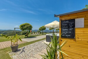 A wooden building with a chalkboard displaying temperatures and a date.