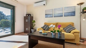 A modern living room with a sofa, coffee table, and artwork on the wall. - Ullastreta by Interhome (La Bisbal D'Emporda)