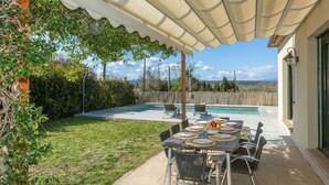 A covered patio with a pool, outdoor seating, and a view of the landscape. - Ullastreta by Interhome (La Bisbal D'Emporda)