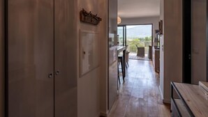 A hallway leading to a balcony with a view of the outdoors. - Résidence Cita Di Sali 12 by Interhome (Porto Vecchio)