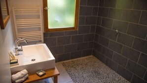 A bathroom with a white sink, a mirror, a towel rack, and a window. - Chalet Jardin Zaza (saint remèze)
