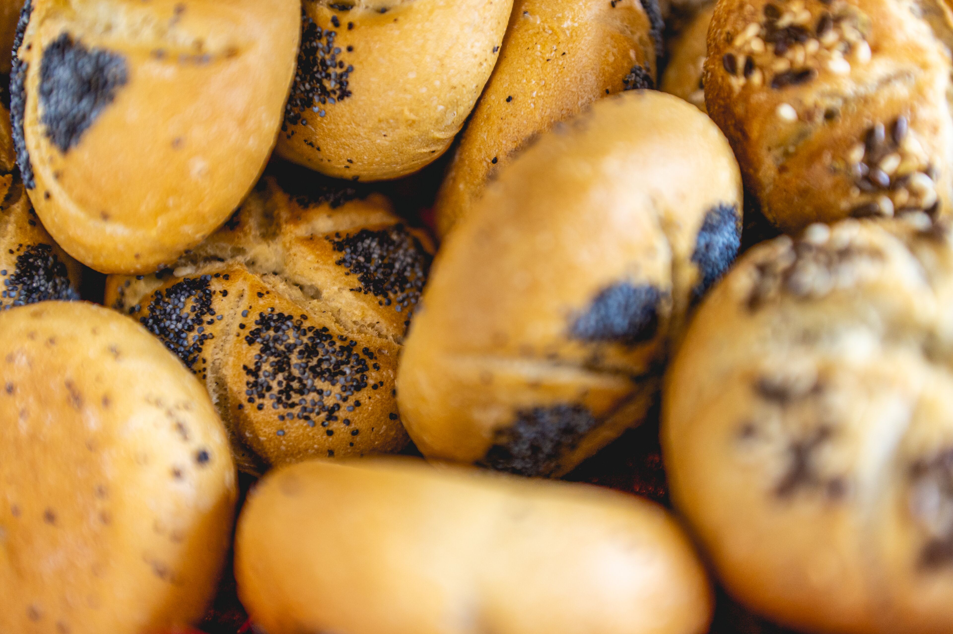 A close-up of various types of bread with seeds.