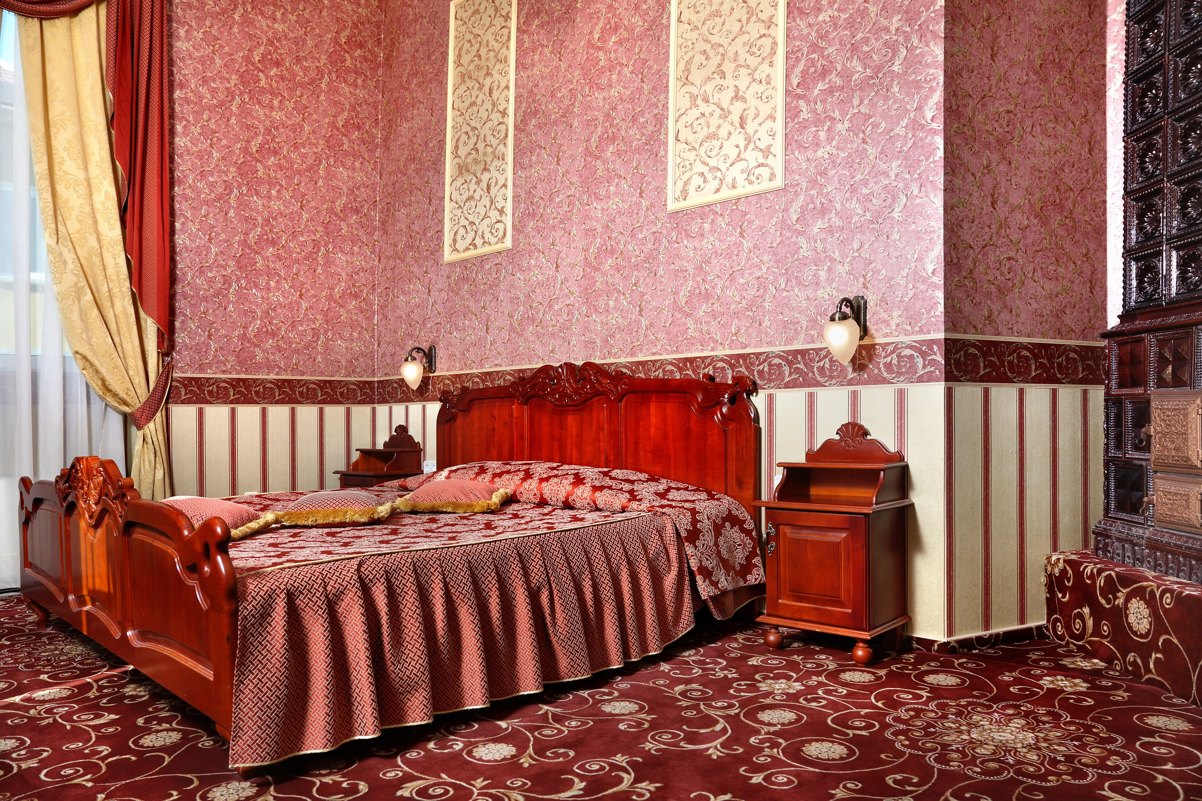 Una camera da letto tradizionale con un letto in legno, un comodino e una cassettiera.