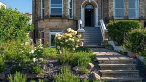 A historic building with a grand entrance, multiple windows, and a well-maintained garden. - Luxury Beachfront Penthouse, Panoramic Sea Views (Herne Bay)
