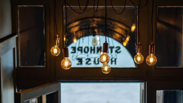 An open door with a view of a beach and a sign reading "STATION HOUSE." - Luxury Beachfront Penthouse, Panoramic Sea Views (Herne Bay)